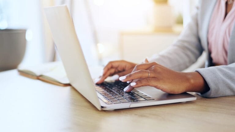 Hands on a laptop keyborad doing typing