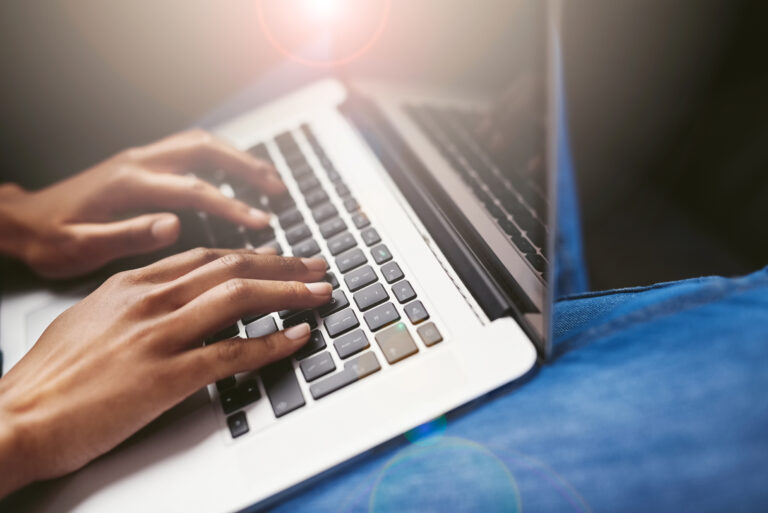 Remote work, hands or person typing on laptop for copywriting, blogging and research for project. Home, keyboard or freelance writer working on technology for email update, connection or online info.